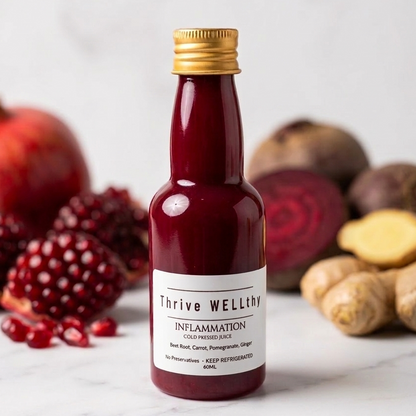 Bottle of 'Thrive Wealthy' inflammation cold pressed juice with pomegranates, beets, and peanuts on a white background